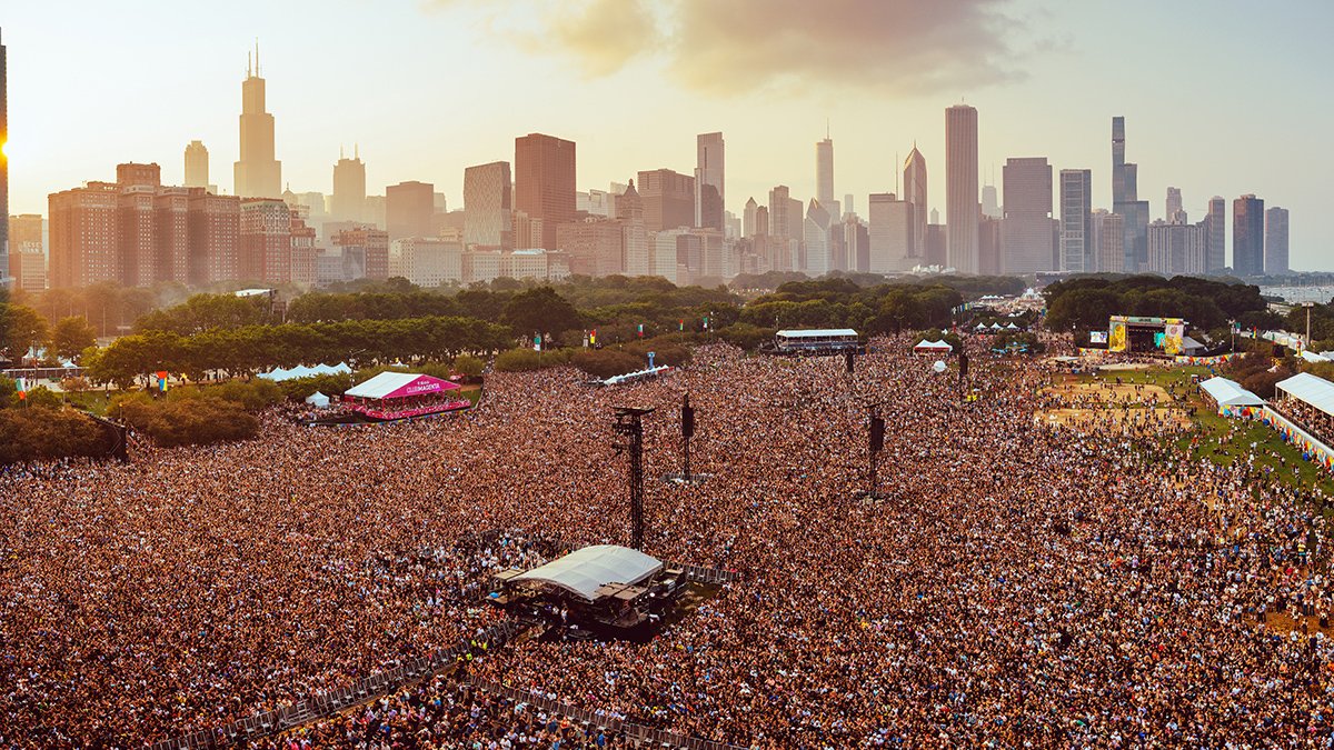 Massive Lollapalooza crowd at golden hour in Grant Park with the Chicago skyline